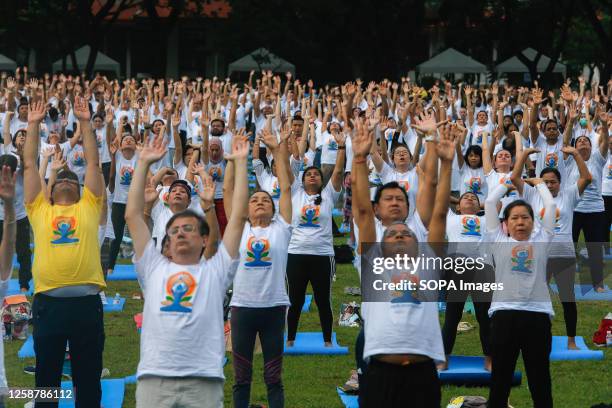 Participants practice yoga to mark the 9th International Day of Yoga, in Bangkok.