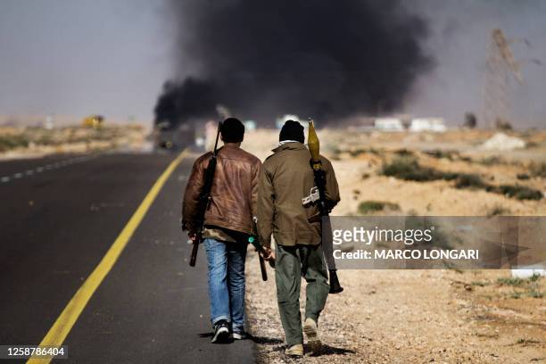 Smoke billows from the fighting in Sidra, 10 kilometres west of Ras Lanuf, on March 10 as fighting in eastern Libya has killed at least 400 people...