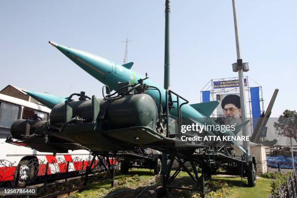 Two Iranian Sayyad-1 surface-to-air missiles and a Zelzal missile are displayed, 26 September 2007, in front of a large portrait of Iran's Supreme...