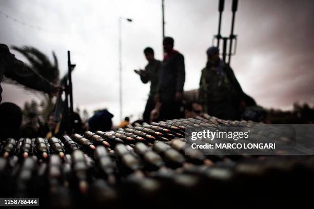 Libyan rebel fighters amass ammunition close to the flashpoint town of Ras Lanuf on March 8 as Libya's air force carries out raids, on this...