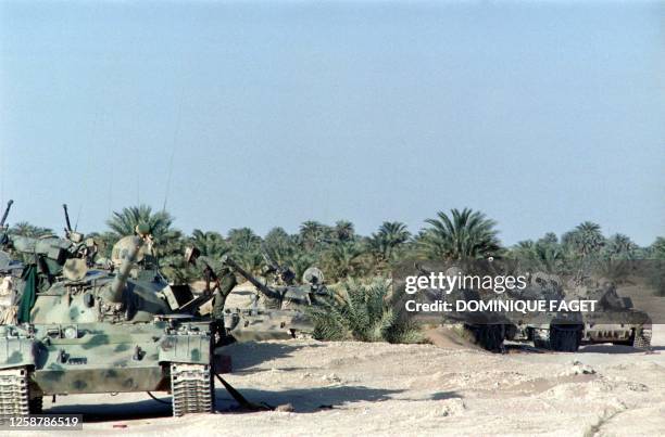 Soldier stands near the abandonned T-54 and T-55 tanks belonging to the Lybian army on April 9, 1987 at Faya-Largeau, after the defeat of Lybian army...