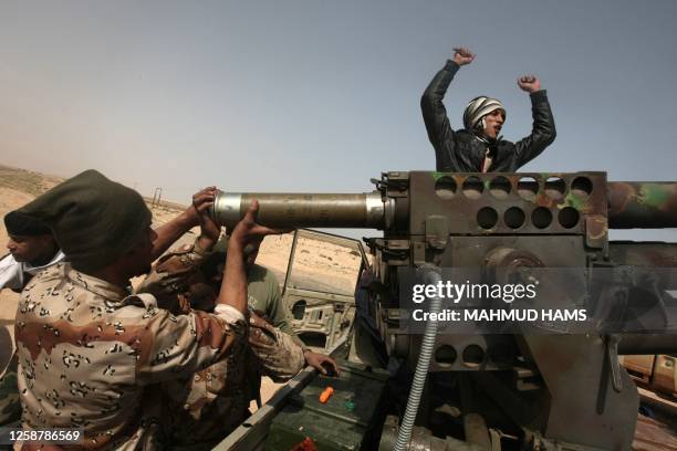 Libyan rebels load a missil launcher after they fled from Ras Lanuf to Uqayla, 20 kilometres further east, on March 30 as loyalist forces overran the...