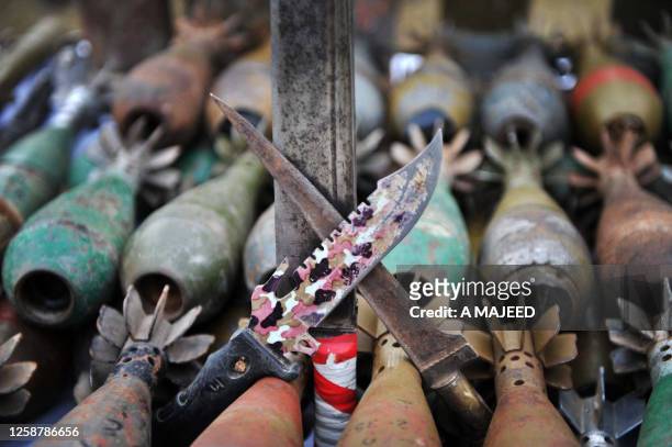 Pakistani security personnel display weapons and ammunition recovered from suspected militants at a media briefing in Bara on December 12, 2009. A...