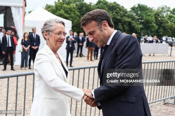 French President Emmanuel Macron greets French Prime Minister Elisabeth Borne as they attend a ceremony marking the 83rd anniversary of late French...