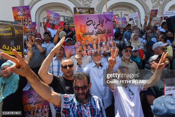 People lift placards demanding the release of political prisoners during a demonstration called for by the opposition National Salvation Front...