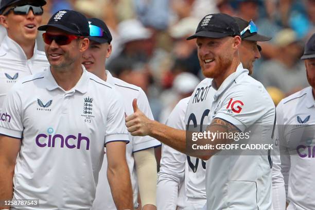 England's captain Ben Stokes gives a thumbs-up sign after England's Ollie Robinson bowls Australia's Usman Khawaja on day three of the first Ashes...