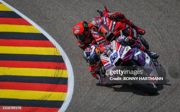 Winner Ducati Pramac Racing Team's Spanish rider Jorge Martin and second-placed Ducati Lenovo Team's Italian rider Francesco Bagnaia race during the...