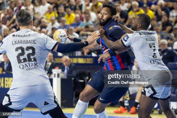 Luka Karabatic of Paris Saint-Germain, Timothey N'Guessan of FC Barcelona and Sadou N'Tanzi of Paris Saint-Germain battle for the ball during the EHF...