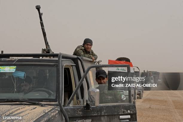 Iraqi forces, supported by members of the Hashed al-Shaabi , advance in al-Hadar desert on June 18 as they search for remnants of the Islamic State...