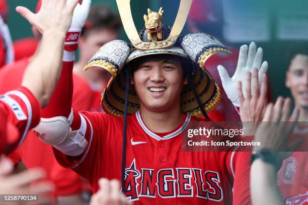 Los Angeles Angels starting pitcher Shohei Ohtani is all smiles in the dugout wearing the Samurai hat after a solo home run in the seventh inning of...
