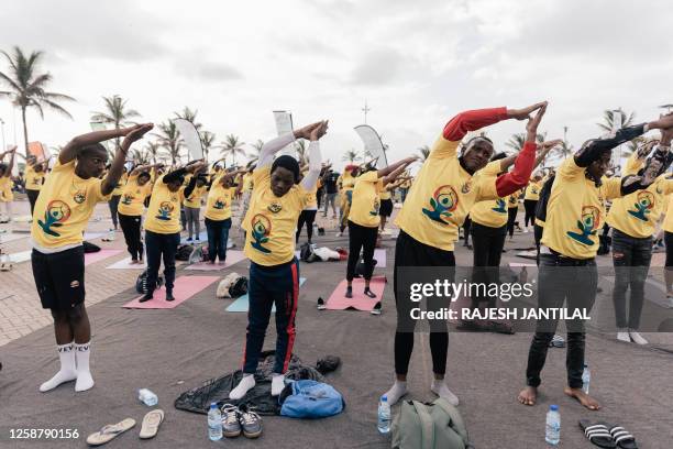 Yoga enthusiasts take part in a mass yoga session at the amphitheatre lawns at North Beach on June 18, 2023 in Durban, South Africa, ahead of the...
