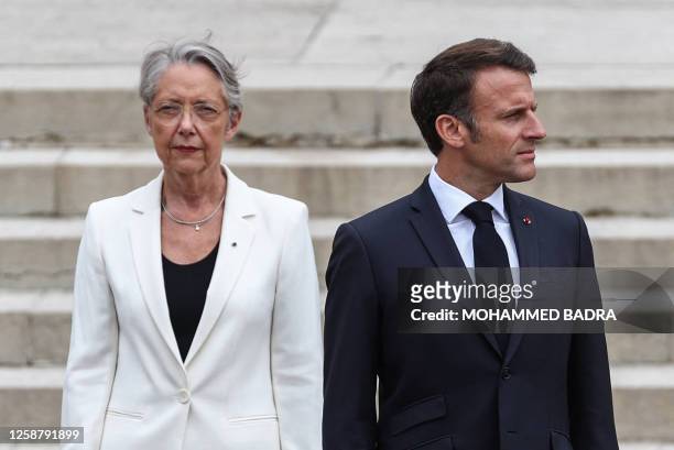 French President Emmanuel Macron and French Prime Minister Elisabeth Borne look on as they attend a ceremony marking the 83rd anniversary of late...