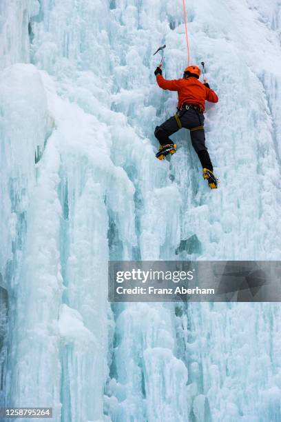 ice climbing, climber rope secured - osttirol stock pictures, royalty-free photos & images