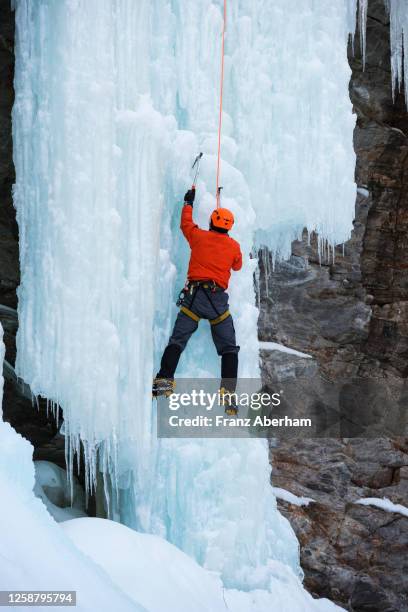 ice climbing, climber rope secured - osttirol stock pictures, royalty-free photos & images