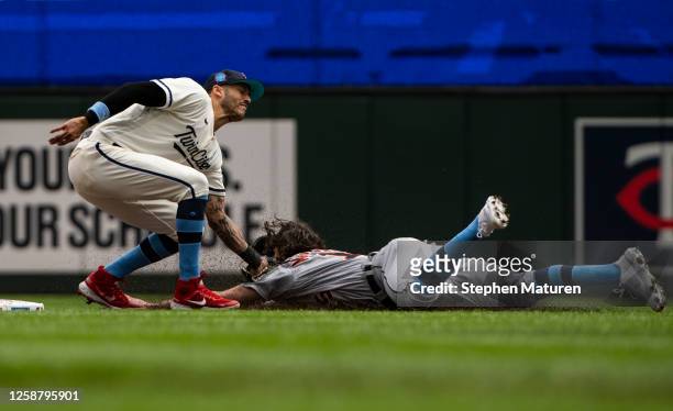 Carlos Correa of the Minnesota Twins tags out Jake Marisnick of the Detroit Tigers to end the second inning of the game at Target Field on June 18,...
