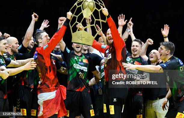 Magdeburg's team celebrates with the trophy after winning the men's EHF Champions league Final 4 Handball Final match SC against Barlinek Industria...