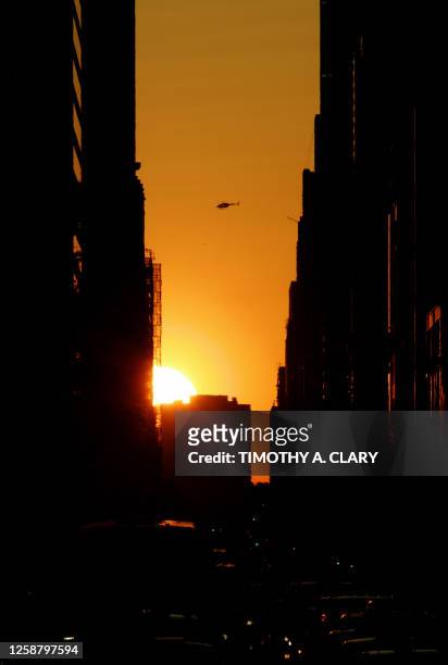 The sun sets 30 May 2007 over the west side of New York City, known as Manhattanhenge, a term coined by an astrophysicist and inspired by Stonehenge....