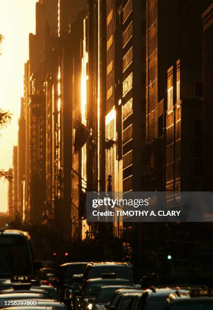 The setting sun is replected on buildings 30 May 2007 on the west side of New York City, known as Manhattanhenge, a term coined by an astrophysicist...