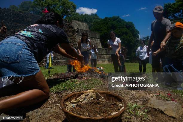 People offer to fire altar during a Summer Solstice celebration ceremony organized by the Mayan council at the Tazumal Archaeological Site on June...