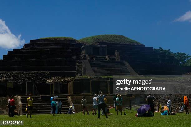 People surround the altar of fire during a Summer Solstice celebration ceremony organized by the Mayan council at the Tazumal Archaeological Site on...