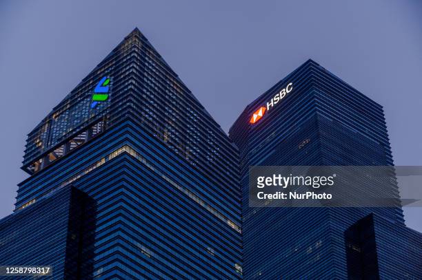 The offices of Standard Chartered Bank, left and HongKong and Shanghai Banking Corporation, or HSBC are seen in Marina Bay Financial Centre in...