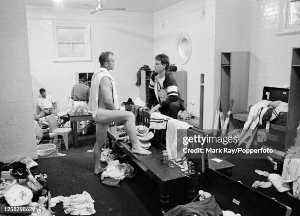 Australian cricketer Greg Matthews of New South Wales, naked apart from a towel, talking with Paul Jackson of Victoria in the dressing room after the...