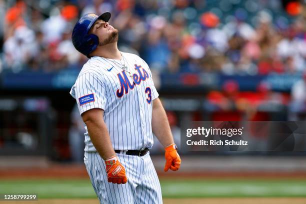 Daniel Vogelbach of the New York Mets reacts after hitting a long fly ball the centerfield against the St. Louis Cardinals in the ninth inning of a...