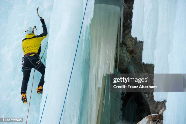 ice climbing, climber rope secured - osttirol stock pictures, royalty-free photos & images