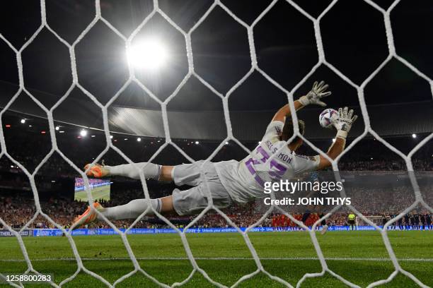 Spain's goalkeeper Unai Simon jumps to stop one of the penalty shootouts during the UEFA Nations League final football match between Croatia and...