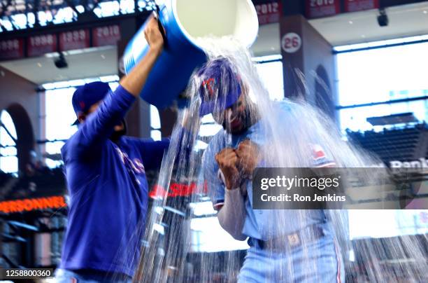 Leody Taveras of the Texas Rangers is doused with sports drink by Martin Perez following an 11-7 win over the Toronto Blue Jays at Globe Life Field...