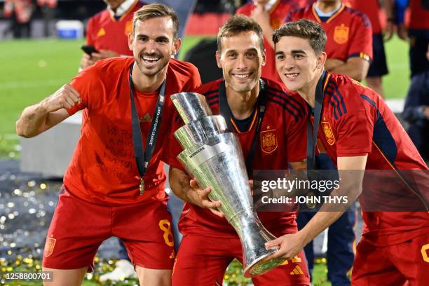 Spain's midfielder Fabian Ruiz, Spain's midfielder Sergio Canales and Spain's midfielder Gavi pose with the UEFA Nations League cup as they celebrate...