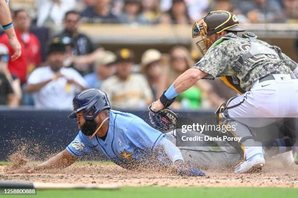 Manuel Margot of the Tampa Bay Rays is tagged out at the plate by Austin Nola of the San Diego Padres during the eighth inning on June 18, 2023 at...