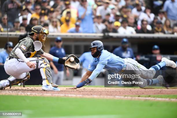 Manuel Margot of the Tampa Bay Rays is tagged out at the plate by Austin Nola of the San Diego Padres during the eighth inning on June 18, 2023 at...