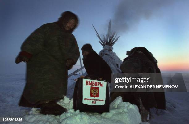 Local Nenets deer shepherds attend a preschedule voting for Russia's presidential elections at their camp in tundra some 200 kilometers from Russia's...