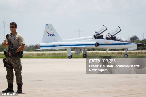 Armed security stands by as the STS-135 crew arrives in T-38 jets at the Kennedy Space Center in Florida on Monday, July 4, 2011. Atlantis is...