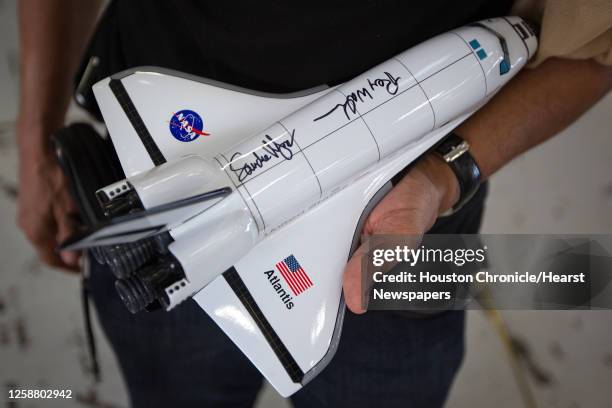 Man shows of the autographs of STS-135 mission specialists Sandy Magnus and Rex Walheim following a welcome home ceremony for the crew of the space...