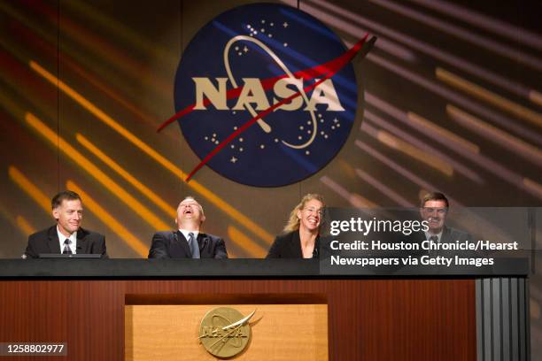 Laughter follows a response to a question by commander Chris Ferguson, left, as the STS-135 crew, pilot Doug Hurley, mission specialist Sandy Magnus...