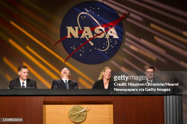 Commander Chris Ferguson, pilot Doug Hurley, mission specialist Sandy Magnus and mission specialist Rex Walheim laugh in response to a statement by...