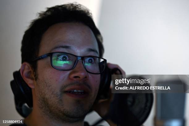 Mexican male voice actor Armando Guerrero speaks during a dubbing session for a television series, inside the recording studio in Mexico City on May...