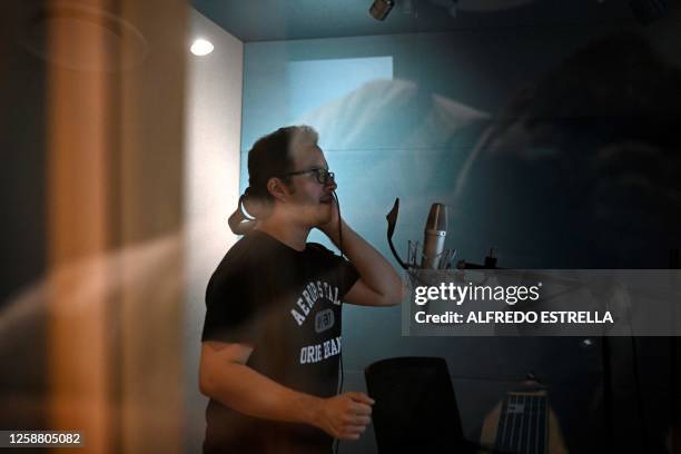 Mexican male voice actor Armando Guerrero speaks during a dubbing session for a television series, inside the recording studio in Mexico City on May...