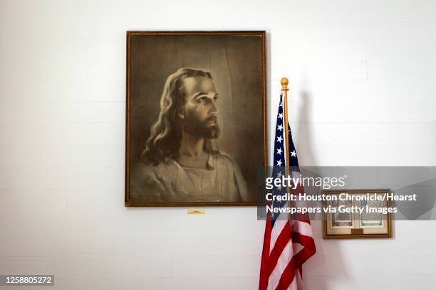 Portrait of Jesus hangs on a wall next to the American flag at Freyburg United Methodist Church on Sunday, March 25 in Freyburg, Texas.