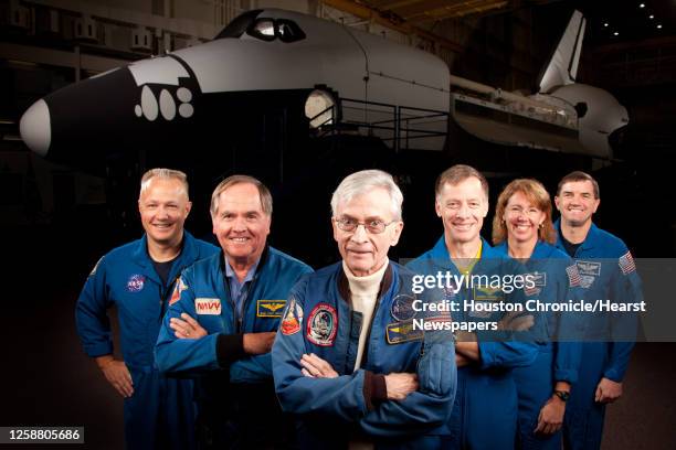 The astronauts who formed the crews of STS-1, the first space shuttle mission, and STS-135, the final shuttle mission, pose for a group photo at the...