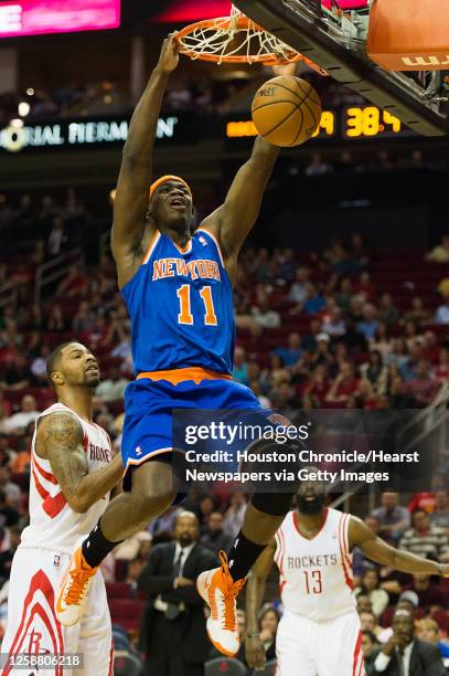 New York Knicks small forward Ronnie Brewer dunks the ball as Houston Rockets power forward Marcus Morris and shooting guard James Harden look on...