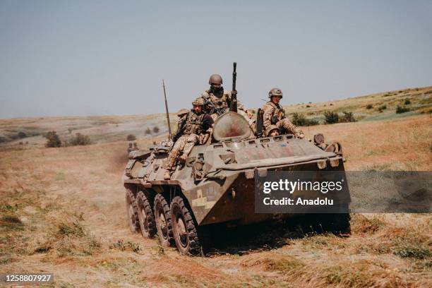 Ukrainian soldiers from the 80th Air Assault Brigade training green tactics, clearing trenches using armored personnel carriers, recoilless guns, and...