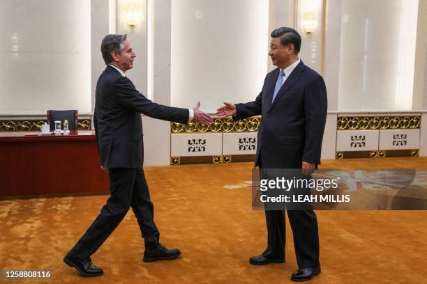 Secretary of State Antony Blinken shakes hands with China's President Xi Jinping in the Great Hall of the People in Beijing on June 19, 2023....