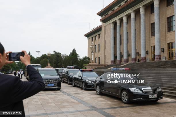 Police vehicles are seen parked outside the Great Hall of the People during a meeting between China's President Xi Jinping and US Secretary of State...
