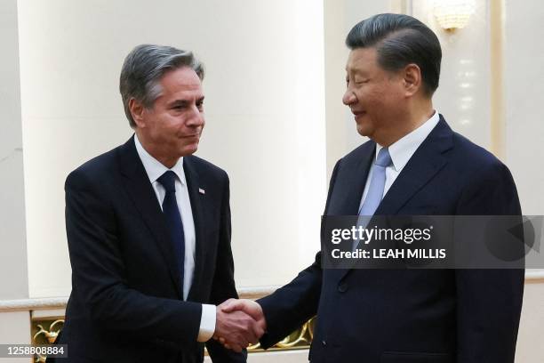 Secretary of State Antony Blinken shakes hands with China's President Xi Jinping at the Great Hall of the People in Beijing on June 19, 2023....