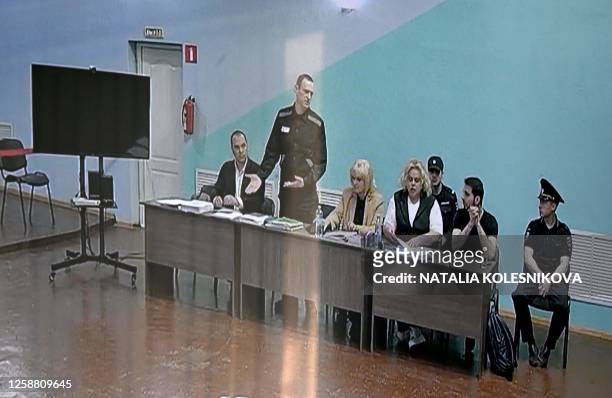 Russian opposition leader Alexei Navalny is seen on a screen during court hearings in the IK-6 penal colony at Melekhovo, about 250 kilometres east...