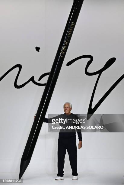 Italian fashion designer Giorgio Armani acknowledges the audience at the end of the Armani Men's Spring - Summer 2024 fashion show as part of the...