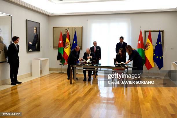 Spain's Prime Minister Pedro Sanchez and Jordan's King Abdullah II stand during the signing of agreements by Spain's Minister for Justice Pilar LLop...